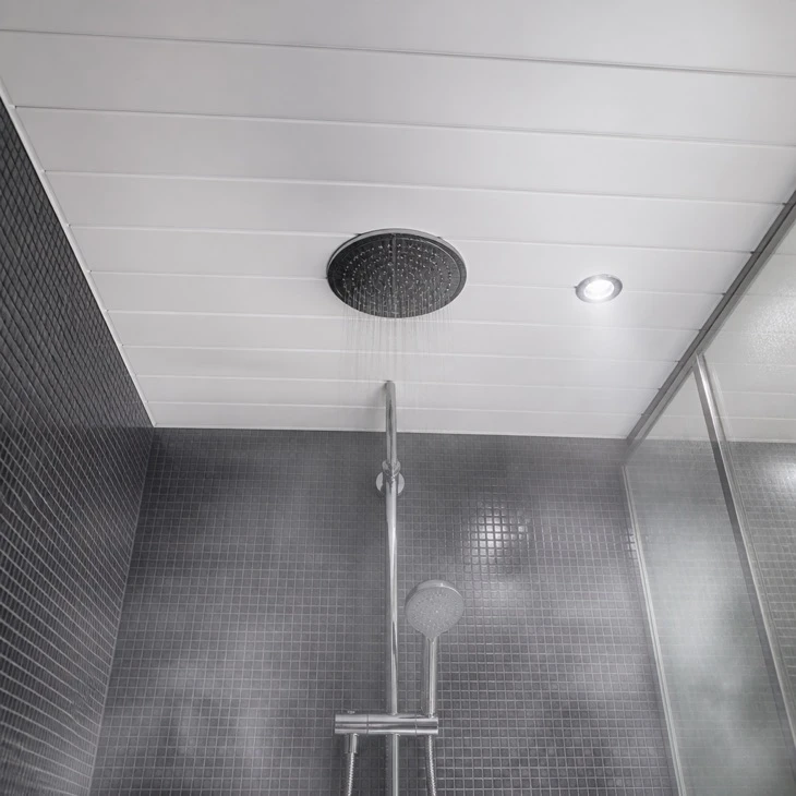 White ceiling panels in wet room shower — waterproof PVC installation